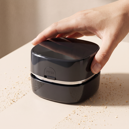 A hand gliding the CleanPod across a desk, leaving a clean path