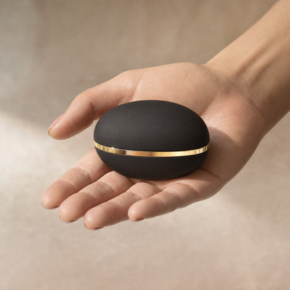 Lustra Mini Straightening Comb held in an open palm, showing its compact travel size